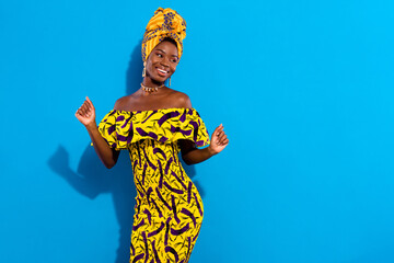 Photo of young happy good mood beautiful african woman dancing look copyspace isolated on blue...