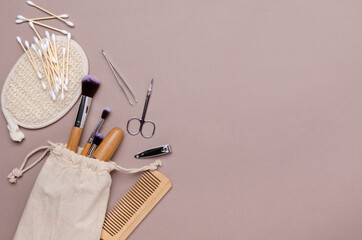 Zero waste beauty products on the beige surface.Manicure set,makeup brushes, body care tools