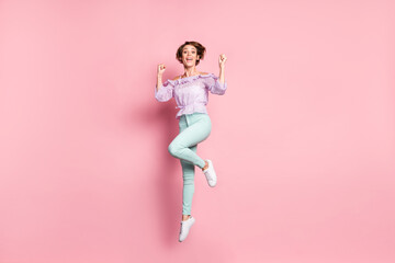Fototapeta na wymiar Full size photo of young lovely happy excited good mood girl jumping in victory success isolated on pink color background