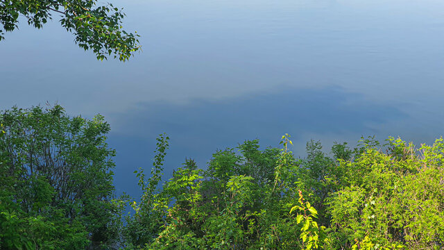 Nature And Empty Beach On The River. Preparing For The Summer Season. Reflection Of Trees In The Water.