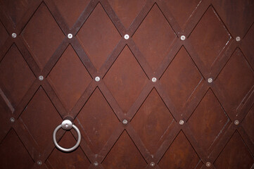 rusty medieval riveted fortification door texture meral triangle rhombus geometrical pattern 