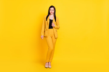 Full body photo of optimistic young work lady stand wear yellow blazer trousers stilettos isolated...