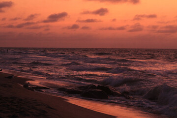 Orange Dawn over Rough Surf