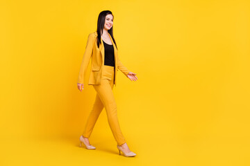 Fototapeta na wymiar Full size profile photo of nice young work lady go wear yellow blazer trousers isolated on vivid color background