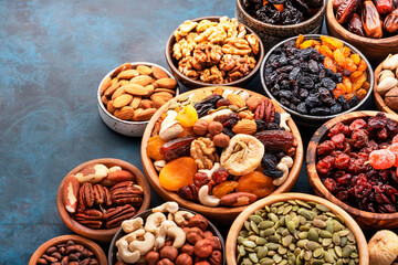Nuts and dried fruits. Dried apricots, figs, raisins, pecans, walnuts, hazelnuts, almonds and other. Blue background, top view