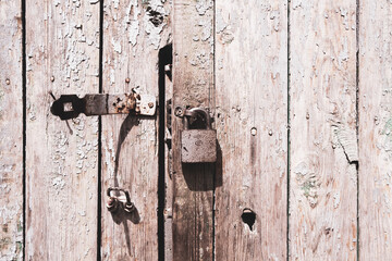 Old wooden doors with lock. Weathered texture background.