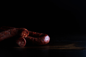 Delicious Chorizo sausage. Spanish traditional chorizo sausage on rustic wooden background.