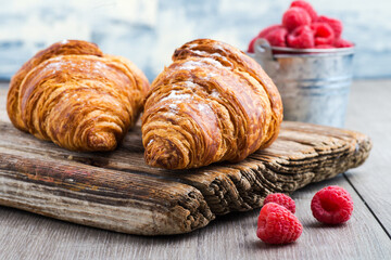 Fresh croissants with raspberry jam close-up.