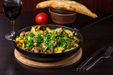 Roasted potato in frying pan, dish in a restaurant.