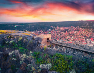 Exciting sunset on Ovech Fortress. Aerial spring cityscape of Provadia town, located in a deep karst gorge along the Provadiya River, Bulgaria, Europe.