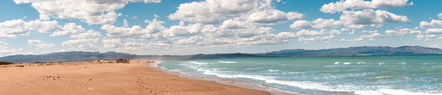 Famous Delta del Ebro beach called "fangar" beach situated in Tarragona, Spain. Picture captured in a sunny day with clouds in the sky. 