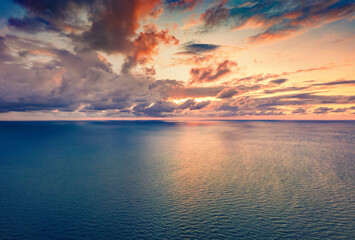 Aerial spring seascape of Adriatic sea. View from flying drone of sunset with endless horizon. Amazing evening in Albania, Europe. Beauty of nature concept background..