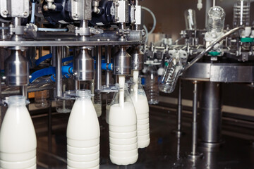 filling milk in to plastic bottles at the factory. equipment at the dairy plant