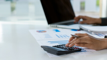 Businessmen analyze financial graph charts that show results and calculate strategies for planning a company's success process.