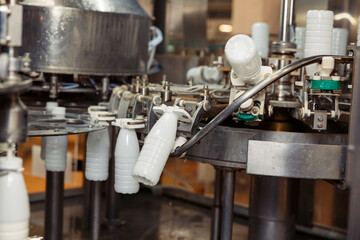 filling milk in to plastic bottles at the factory. equipment at the dairy plant