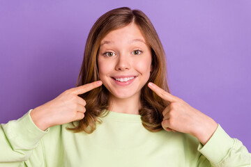 Fototapeta premium Photo of young cheerful girl happy positive smile point fingers teeth stomatology isolated over violet color background