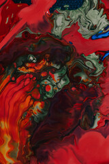 Vertical shot of an abstract painting with mixed red oil paint colors - perfect for wallpapers