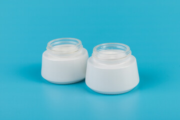 Beauty Cream Texture Close Up. Cosmetic skincare product in jar on blue background. High Quality