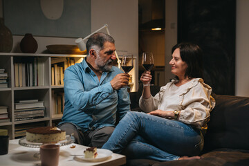 couple toasting with red wine at home