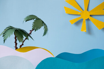 Two palm trees on a sandy island under the sun in the sea with paper waves.