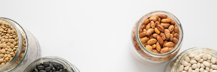 Variety of legumes in glass jars. Zero waste storage, no plastic, healthy eating, natural protein food concept
