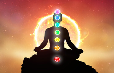 Chakras and meditating men in yoga lotus position. Mindfulness and self awereness practice. Silhiuette of meditation with chakras on sun background. - obrazy, fototapety, plakaty