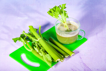Healthy Celery diet for the treatment of incurable mysterious diseases. Fresh celery juice squeezed out on a juicer.drink, vegetable juice, studio shot
