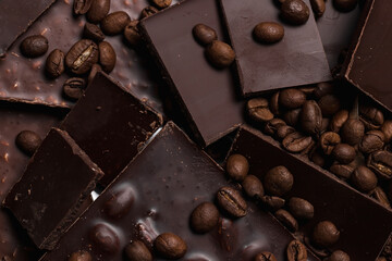 coffee beans close-up and chocolate. Dark chocolate bar. Natural background of cinnamon color.