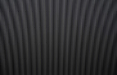 Black corrugated iron sheet used as a facade of a warehouse or factory. Texture of a seamless corrugated zinc sheet metal aluminum facade. Architecture. Metal texture.