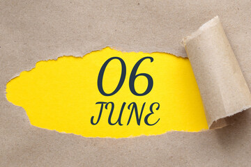 june 06. 06th day of the month, calendar date.Hole in paper with edges torn off. Yellow background is visible through ragged hole.Summer month, day of the year concept