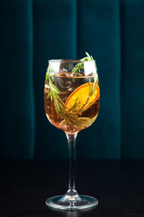 Aperol Stpritz cocktail with ice cubes and slices of orange at black background. Classic Italian aperitif beverage