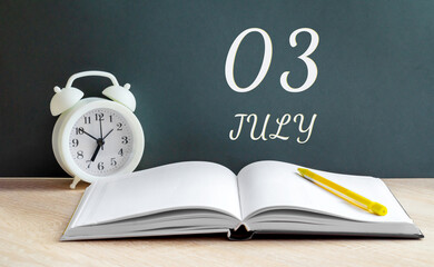july 03. 03-th day of the month, calendar date.A white alarm clock, an open notebook with blank pages, and a yellow pencil lie on the table.Summer month, day of the year concept