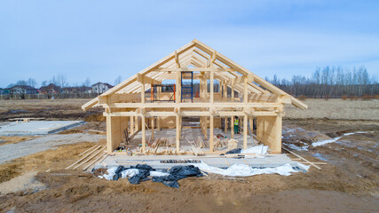Country building. Building a house from wood. Wooden frame on a blue sky background. Frame house is...
