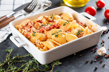 Baked vegetables with feta cheese, olives, onions, Provencal herbs, olive oil, spices and tomatoes. Home cooking concept.