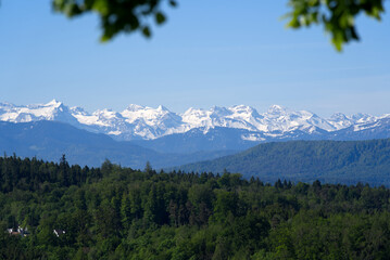 Panoramic view on Swiss alps from hill at City of Zurich at springtime. Photo taken May 28th, 2021, Zurich, Switzerland.