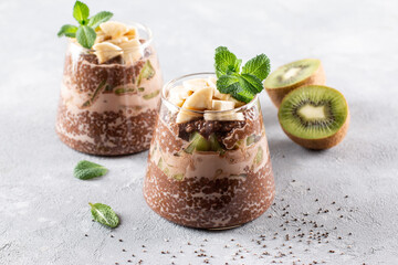 Chia seed pudding with chocolate on a gray background. Healthy food.