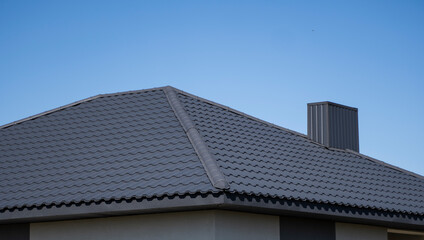 Brown corrugated metal profile roof installed on a modern house. The roof of corrugated sheet....