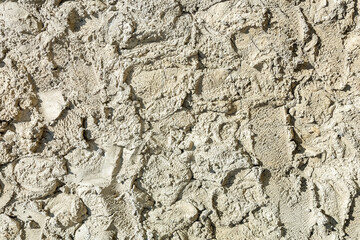 Repair work. A rough layer of plaster is applied to the wall outside the building. As a natural background and texture.