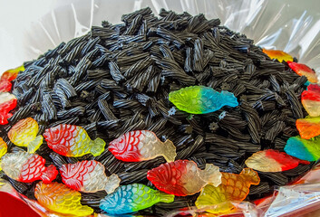 Photo shows gummies, rainbow fish and black liquorice toppers