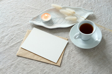 Romantic breakfast cocnetp. Blank postcard mockup, envelope, cup of coffee, candle, dried grass top...