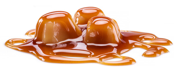 Caramel candies covered with melted sugar caramel isolated on white background.