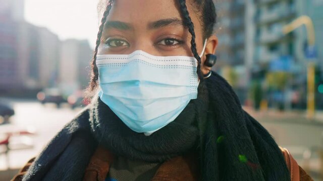 Portrait of young woman in face mask on street, Italy
