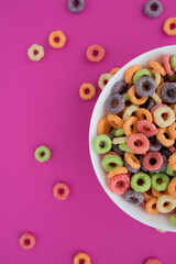 Obraz na płótnie Canvas multicolored bright dry breakfast on pink background