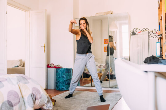Young woman exercising at home