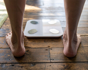 East Sussex, Close-up of senior mans feet at bathroom scale