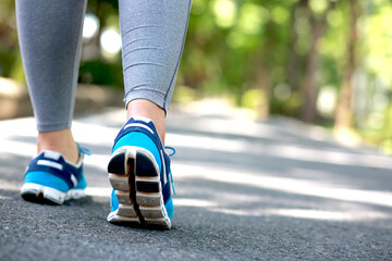 Woman is walking exercise at the park