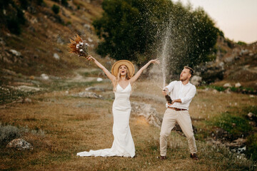 bride and groom sprinkle with champagne, wedding,  two young people in love	
