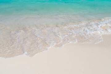 Fototapeta na wymiar Wave on white sand beach