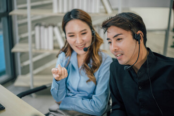 Asian customer support team with headset working at office.
