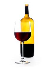 A tall-stemmed glass of red wine in front of wine bottle. All dust and scratches has been removed. Isolated on white